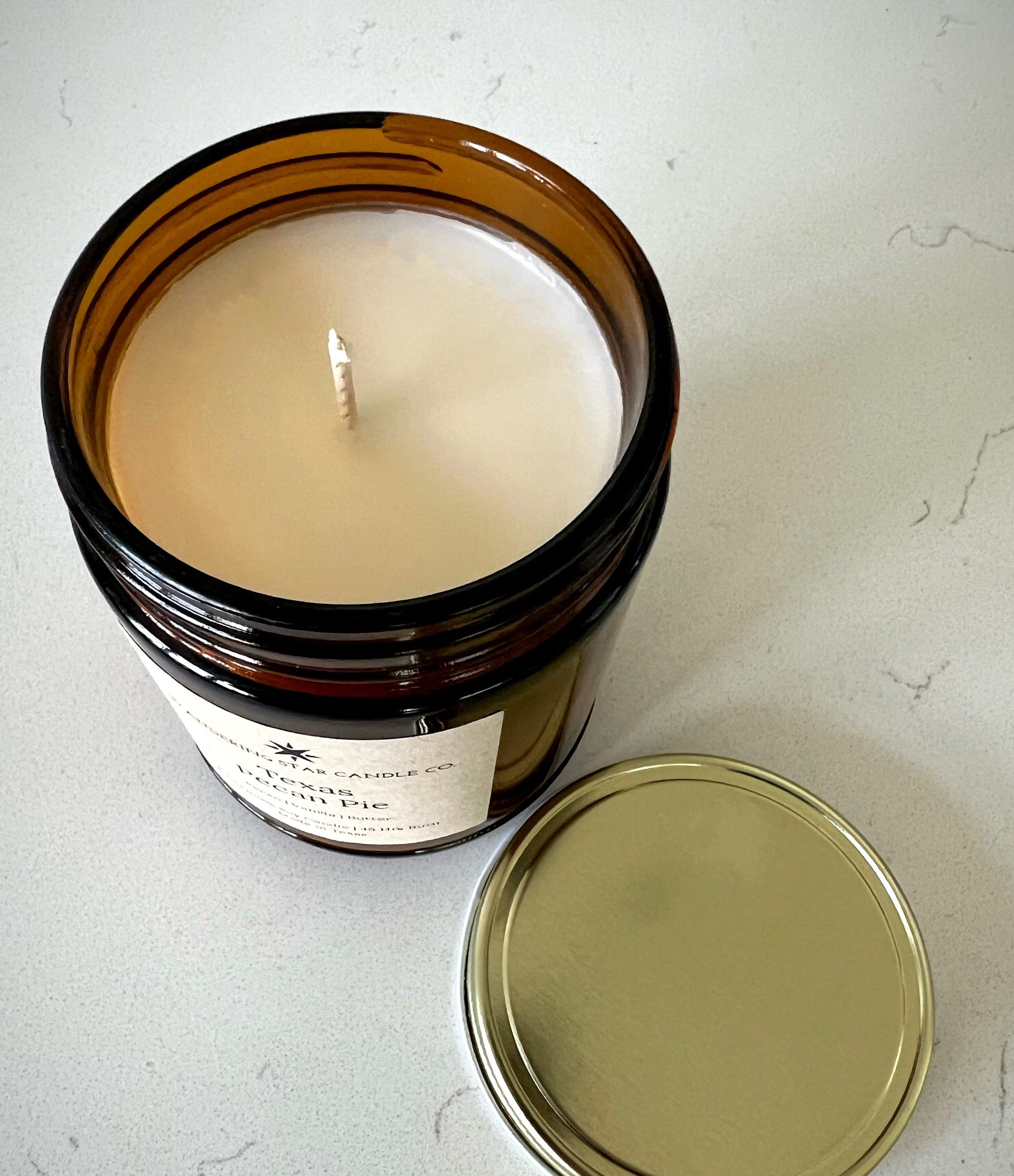 Top view of an un-lit amber jar candle in the scent of Texas Pecan Pie